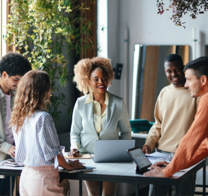 4 Employees together smiling in an office